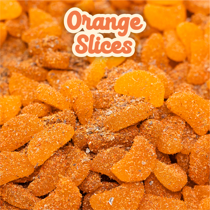 Photo of a pile of Noms Orange Slices gummies shaped as orange slices covered in li hing powder and lemon peel.